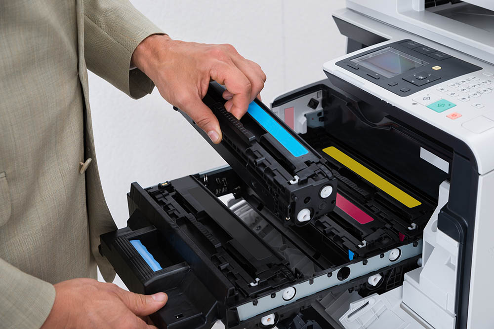 Man loading Inks into printer